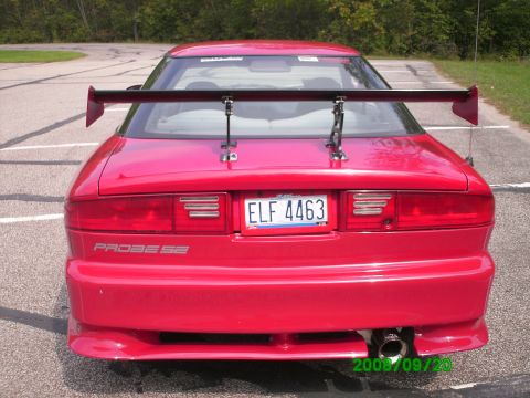 1994 Ford Probe - Rear view of a red 1994 Ford Probe SE, equipped with a prominent rear spoiler and aftermarket exhaust.