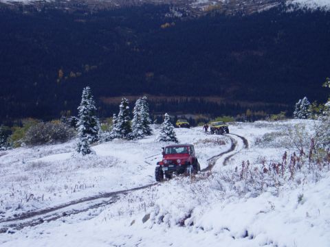 2000 Ford E350 - Jeeps navigate a snowy mountain trail during an off-road excursion.