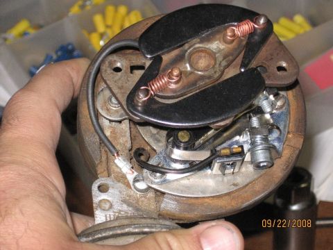 1961 International Scout 800 - A hand holds a vehicle's distributor cap and points assembly, with a date stamp visible in the corner.