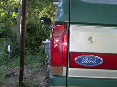 1990 Ford Bronco - Rear view of a 1990 Ford Bronco showing the taillight and Ford emblem on the tailgate.