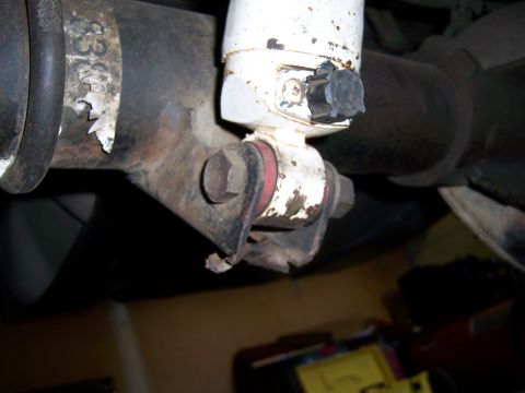1991 Ford Bronco - Close-up of the rear shock mount assembly on a 1991 Ford Bronco, showing the connection to the axle.