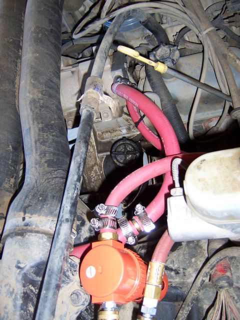1991 Ford Bronco - Close-up view of an engine bay, highlighting an aftermarket air compressor and associated plumbing.
