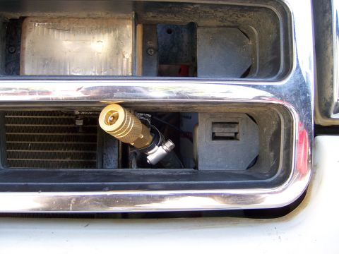 1991 Ford Bronco - A quick connect fitting for an air compressor is mounted in the front grille of a vehicle.