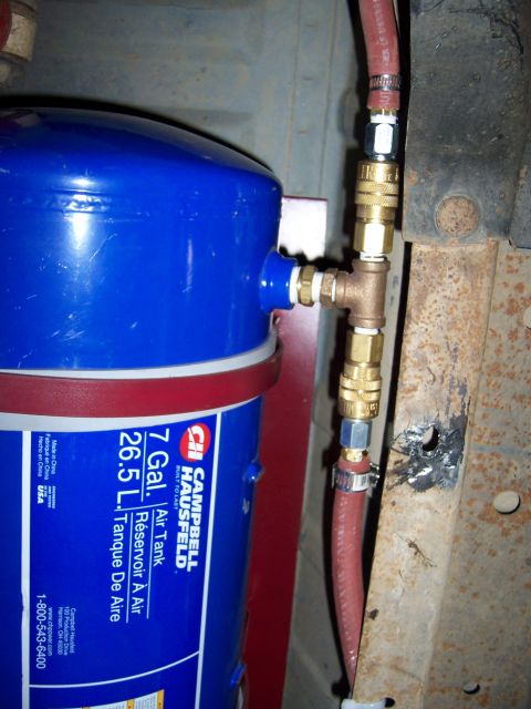 1991 Ford Bronco - A blue Campbell Hausfeld 7-gallon air tank is plumbed with brass fittings and a red hose, mounted to a vehicle frame.