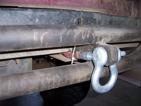 1991 Ford Bronco - Close-up of a metal shackle attached to a vehicle's rear frame for towing or recovery.