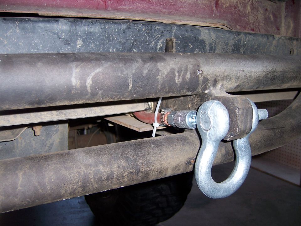 Shackle attached to a vehicle's tow hitch receiver