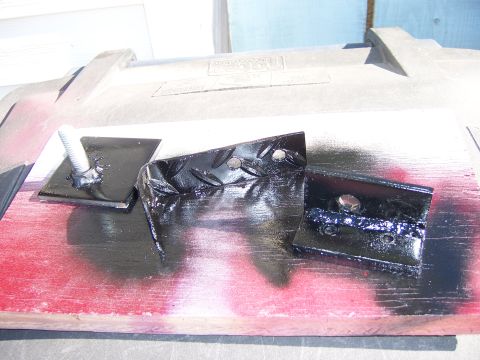 1991 Ford Bronco - Three metal brackets, one with a diamond plate pattern, are shown with bolts attached.