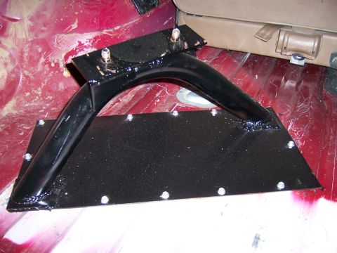 1991 Ford Bronco - Custom spare tire carrier mount is bolted to the floor of a vehicle's interior.