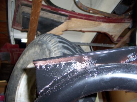 1991 Ford Bronco - Close-up of a spare tire and part of a vehicle's interior framing, showing welds and wear.