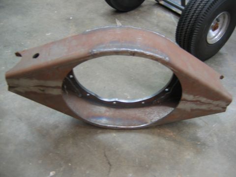 1992 Ford Mustang - This is a rusted metal part with a large circular opening and bolt holes, possibly for a vehicle.