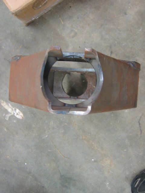1992 Ford Mustang - A fabricated metal component with a rough, oxidized surface sits on a concrete floor.