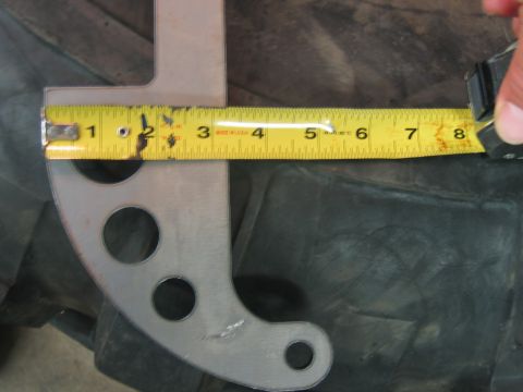 1992 Ford Mustang - Measuring a custom metal bracket on a tire with a tape measure.
