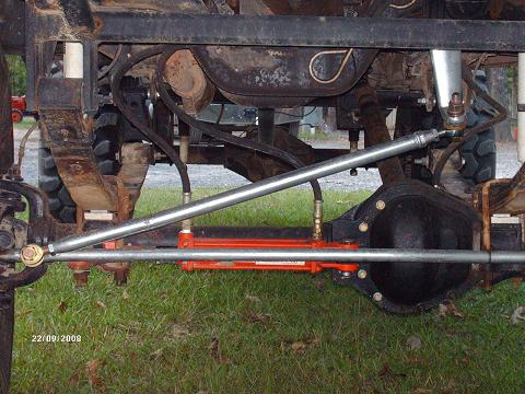 1990 Ford F-150 - Undercarriage view shows a modified steering system with hydraulic assist and heavy-duty suspension components.