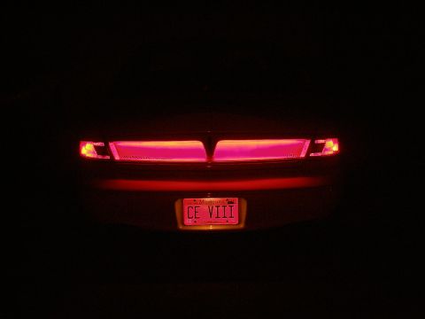 1998 Lincoln Mark VIII - The distinctive rear taillights and "CE VIII" license plate of a 1998 Lincoln Mark VIII are visible in this night shot.