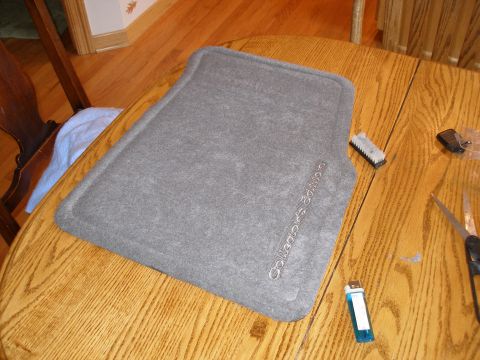 1998 Lincoln Mark VIII - A gray floor mat with 'Collector's Edition' text is on a wooden table.
