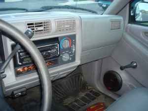 2006 Ford E350 - The interior of a vehicle is shown, the dashboard, steering wheel, and an aftermarket stereo system.