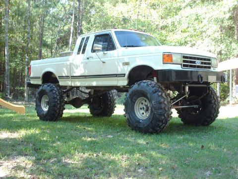 1990 Ford F-150 - This lifted Ford pickup truck is modified with large tires and suspension for off-road use.