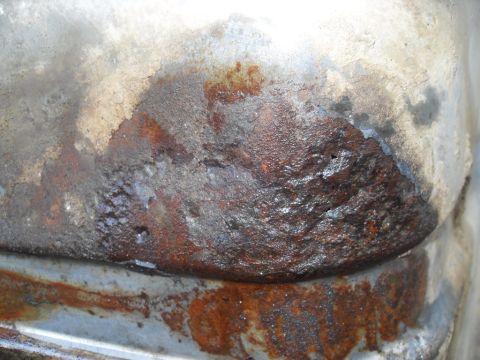 1990 Ford Bronco - Close-up view of severe rust and corrosion on a vehicle's metal components.