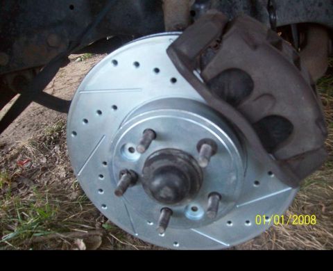 2000 Mercury Grand Marquis - Car brake rotor and caliper assembly with a date stamp of 01/01/2008.