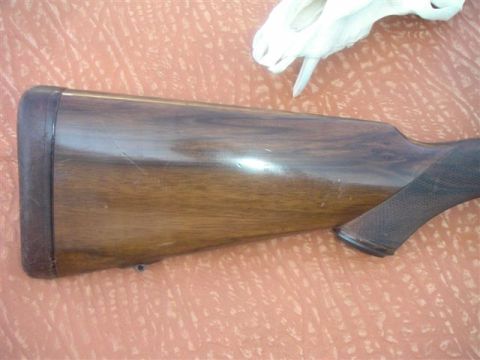 1991 Ford Bronco - Wooden gun stock shown from the side, with a dark butt plate and textured grip.