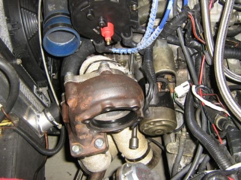 1995 Ford Probe - Engine bay components including a turbocharger and starter motor are visible in this close-up shot.