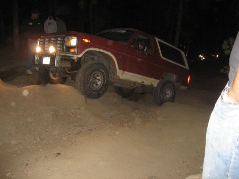 1986 Ford Bronco - This 1980s Ford Bronco is navigating rough terrain in the dark.