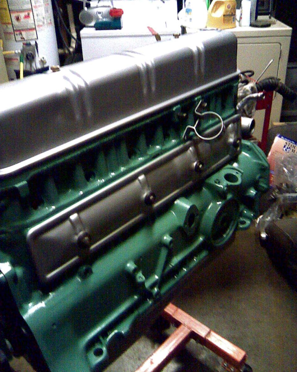 Green engine block with silver valve cover, engine view