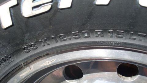 1996 Ford Bronco - Close-up of a tire and wheel assembly, showing tire size information.