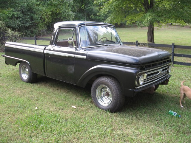 Black 1966 Ford F-100 pickup truck, 3q-front view