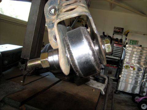 1996 Ford Bronco - Suspension component being worked on in a garage setting.