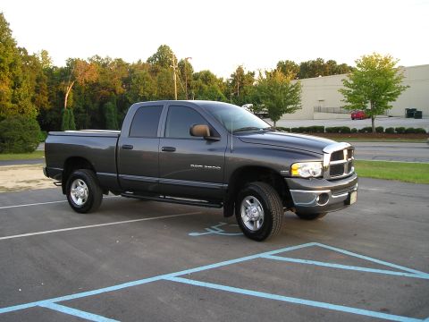 1989 Ford Bronco - This dark gray Dodge Ram pickup truck is parked in a lot. The model appears to be from the early 2000s.