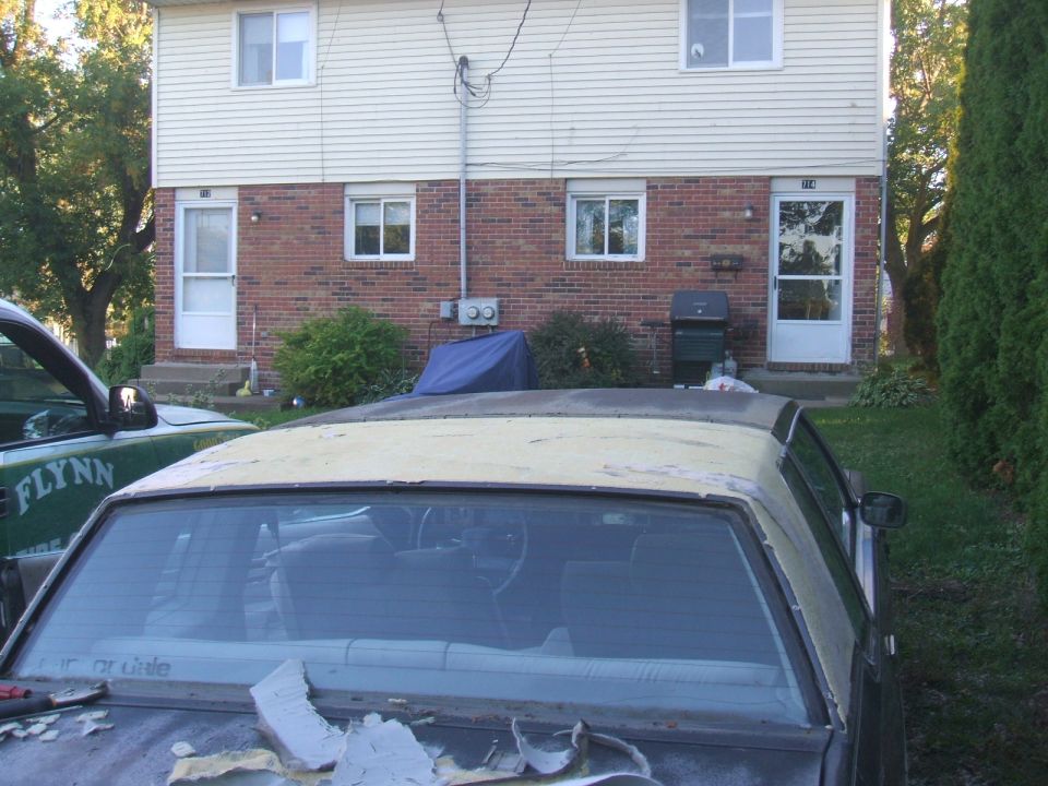 view of car interior and roof, another car is partially visible on the left