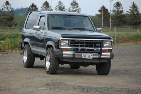 1984 Ford Bronco II - Front view of a 1984 Ford Bronco II with a bull bar and aftermarket wheels.