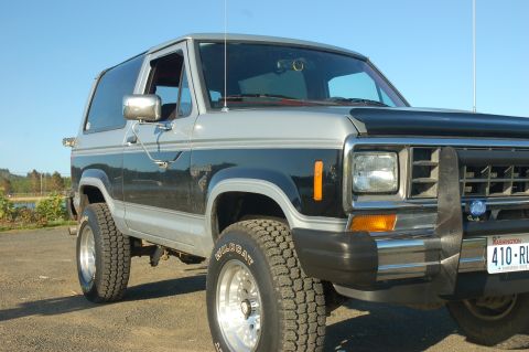 1984 Ford Bronco II - This 1984 Ford Bronco II is shown in a three-quarter front view, parked outdoors under a clear blue sky.