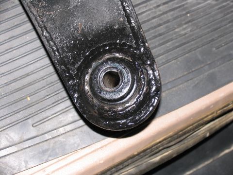 1984 Ford Bronco - A close-up view of a vehicle's suspension component, showing wear and weld details.
