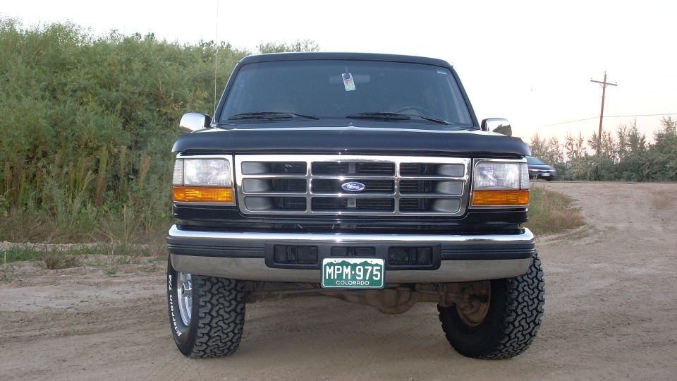 Front view of a black Ford Bronco with a chrome grille and a Colorado license plate