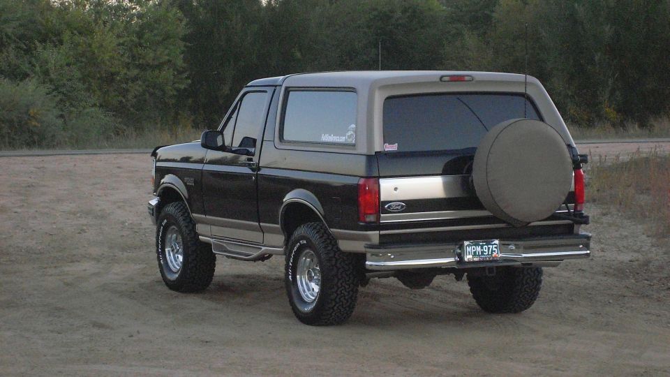 Black and tan 1996 Ford Bronco with spare tire on rear door