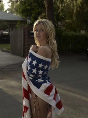 1996 Ford Bronco - A woman poses outdoors, wrapped in the American flag, with a house and trees in the background.