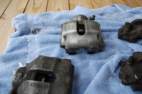 2002 BMW M3 - BMW M brake calipers shown on a blue towel, with part numbers visible on some.