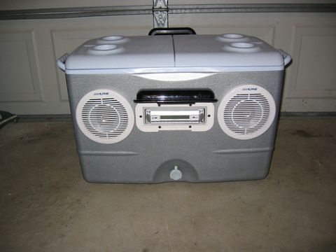 1992 Ford Bronco - A cooler has been modified with two speakers and a car stereo, set against a garage door.