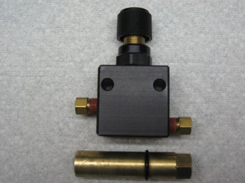 1968 Shelby GT500 - A black proportioning valve with brass fittings is shown, separate from a brass tube with o-rings.