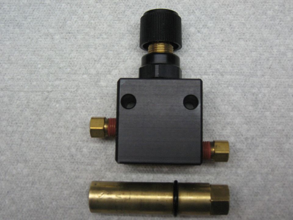 Black proportioning valve with brass fittings and a black knob