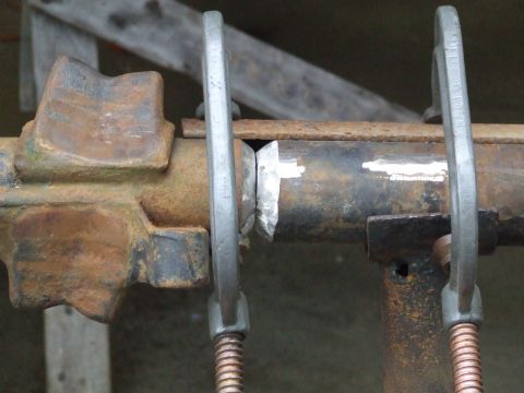 1967 Ford Bronco - Axle housing clamped in place for repair work, showing rust and metalwork.