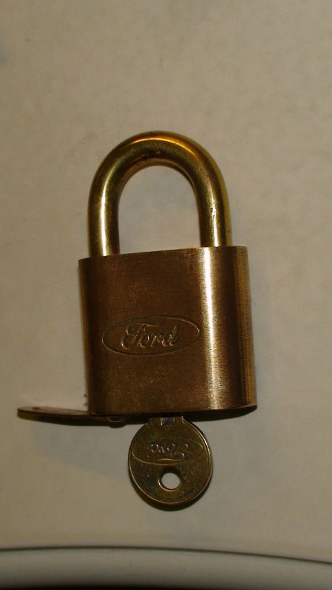 1979 Ford Bronco - Ford branded padlock with its key. The logo is embossed on the body.