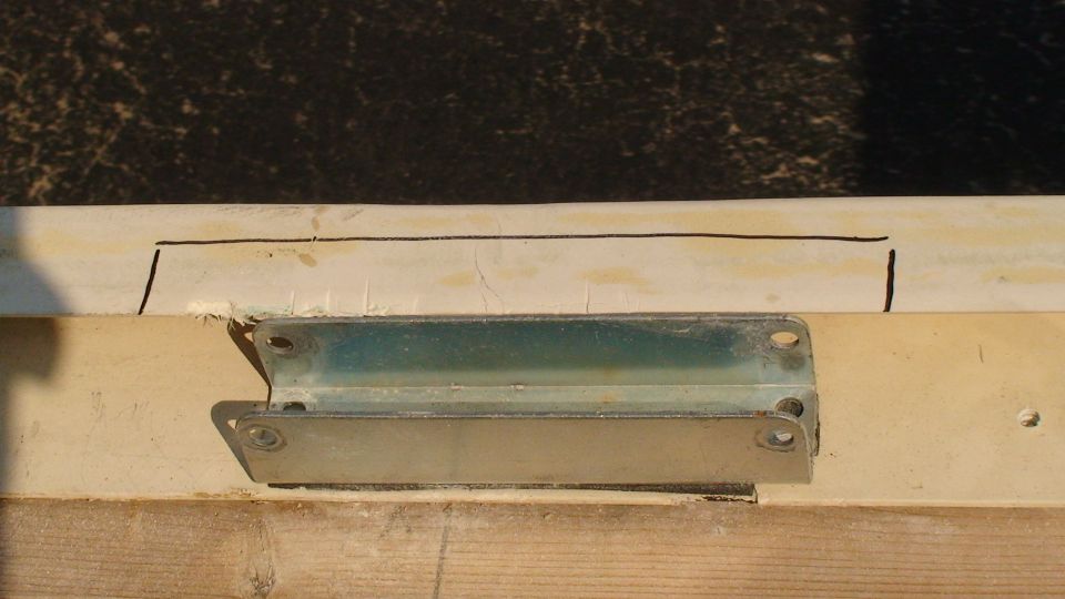 Metal offset bracket positioned on a cream body rail marked with black layout lines
