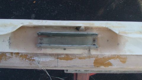 1979 Ford Bronco - A close-up view of a fiberglass panel with metal mounting brackets, likely a custom part.