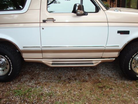 1992 Ford Bronco - Side view of a 1992 Ford Bronco showing the door, running board, and wheel.