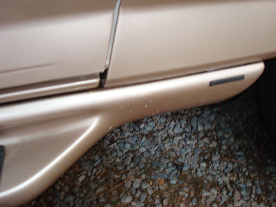 Side body panel and trim on a tan vehicle