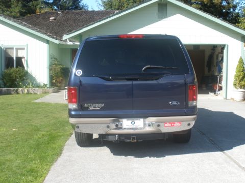 2002 Ford Excursion - Blue 2002 Ford Excursion Limited parked in front of a house and garage.