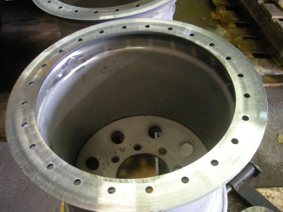 close-up of a large metal wheel rim with many bolt holes
